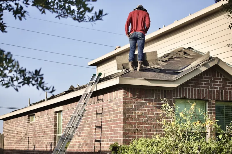 Professional roofer working on a residential roof in Highline